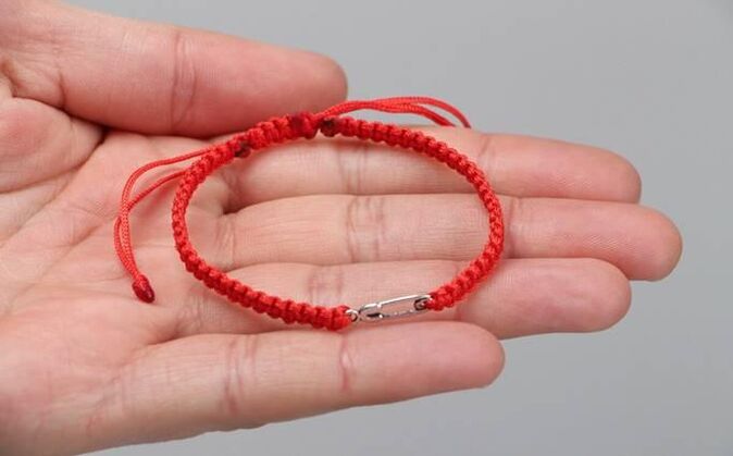 Red thread that protects from evil (on left wrist) and attracts happiness (on right wrist)